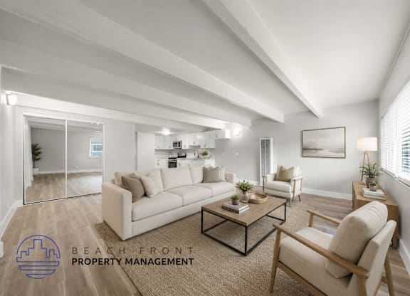 A well-lit, modern living room with a large mirror and a coffee table.