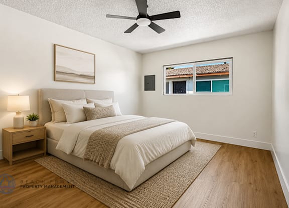A bedroom with a large bed and a ceiling fan.