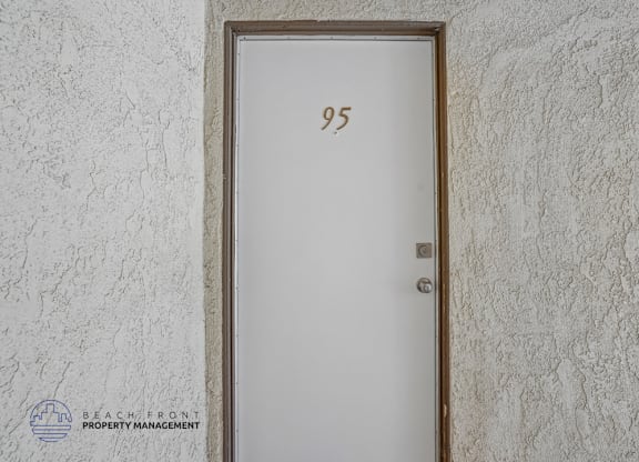 A door with the number 95 on it is set into a wall.