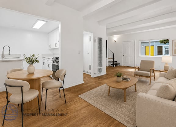 A living room with a dining table and chairs.