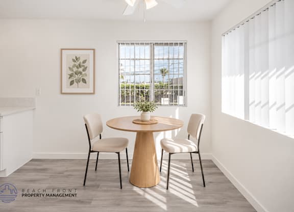 A dining room with a round table and chairs.