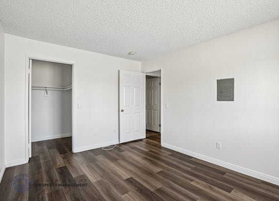 A room with a wooden floor and white walls.