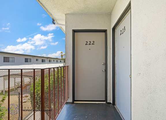 A balcony with a door numbered 222 and a window numbered 223.