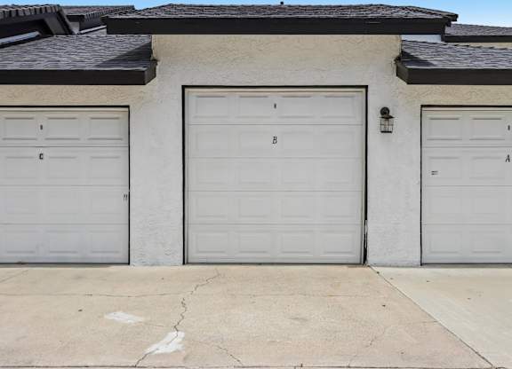 Three garage doors are closed and labeled A, B, and C.