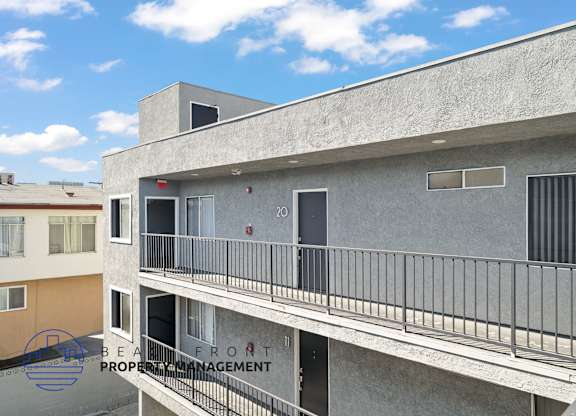 A building with a balcony and a sign that says