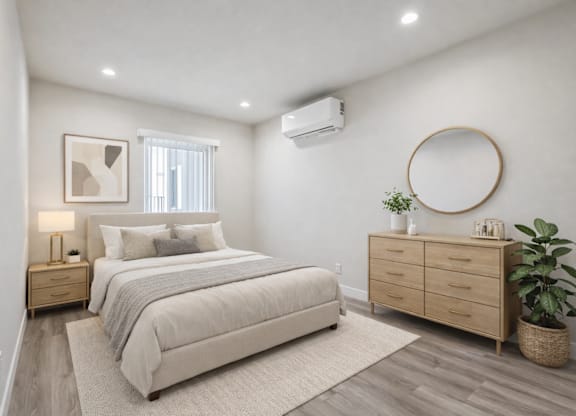 A bedroom with a large bed, a nightstand, and a dresser.