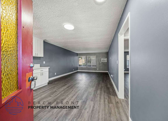 A hallway with a red door and a sign that says