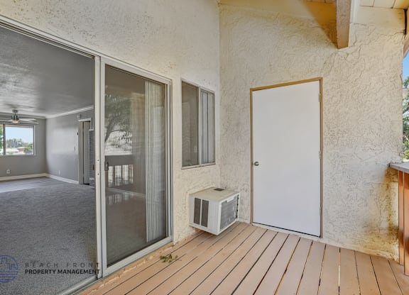 A room with a sliding glass door and a white door.