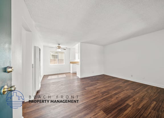 a living room with a vinyl planks floor and white walls