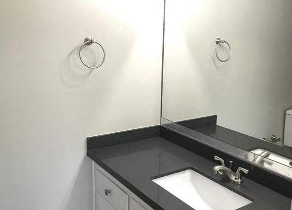 A bathroom with a sink and a mirror.