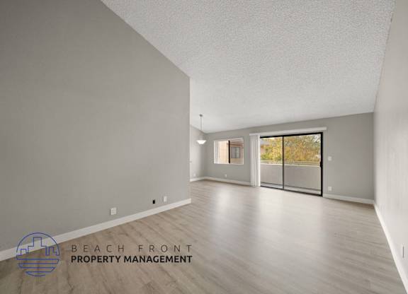 the renovated living room and dining room with wood flooring