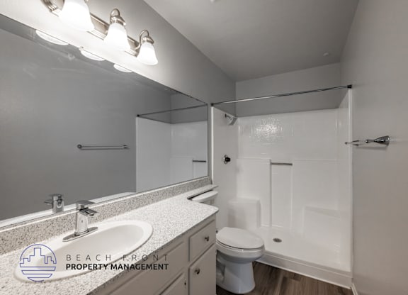 A bathroom with a sink, toilet, and bathtub.