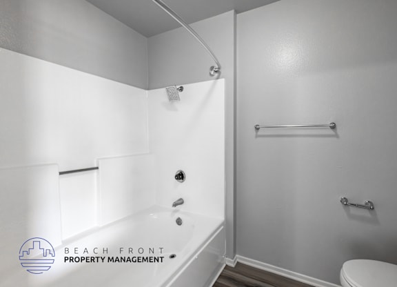A white bathroom with a toilet, sink, and bathtub.