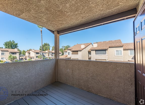 A balcony with a view of a residential area.