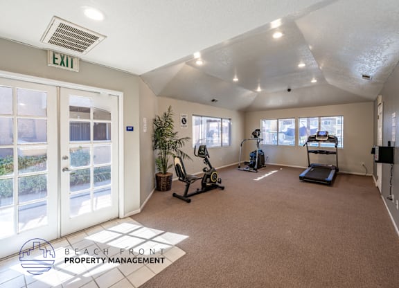 A gym with a treadmill, exercise bike, and weights is labeled as an exit.