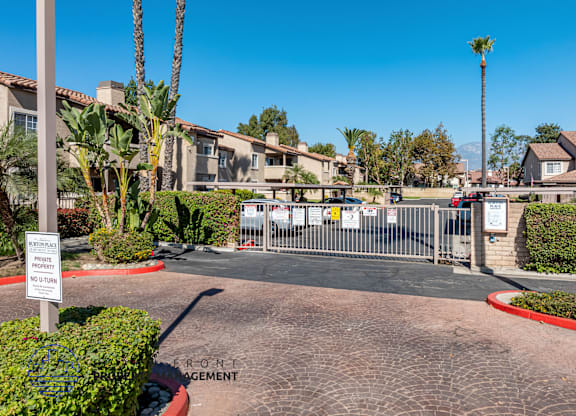A gated community entrance with a sign that says