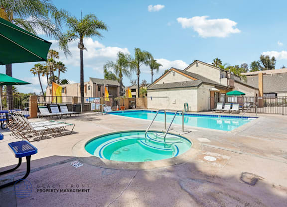 A pool with a slide and a fence around it.