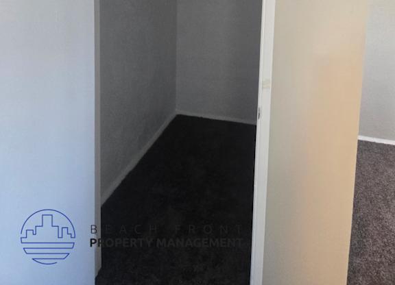 A small, empty room with a doorway leading to another room.