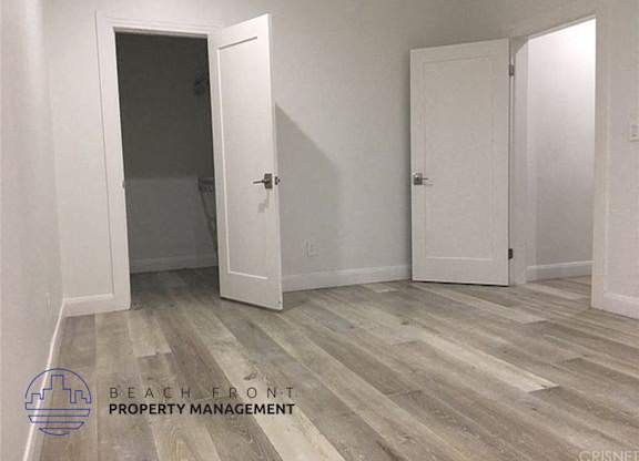an empty room with white walls and white doors