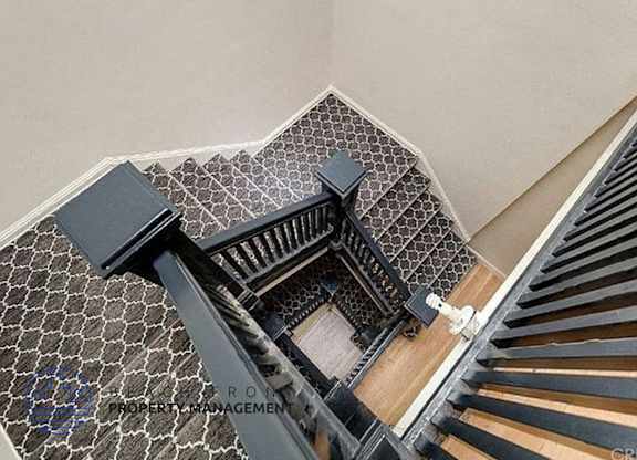 a view of a stairwell with a black railing