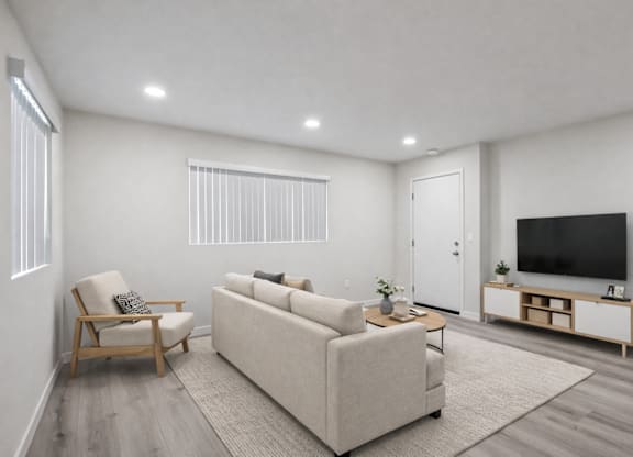 A living room with a couch, chair, and television.