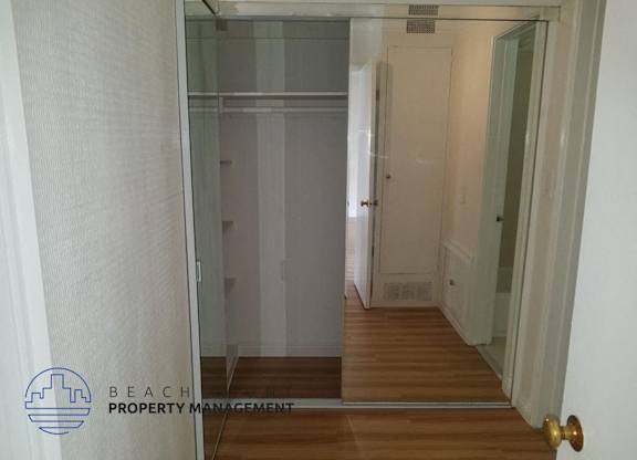 a glass door in a hallway leading to a closet