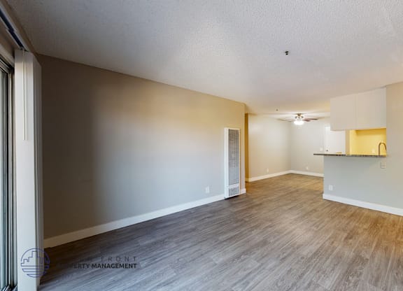 A room with wooden flooring and a white ceiling.