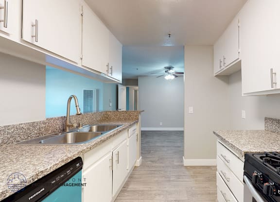 A kitchen with granite countertops and stainless steel appliances.