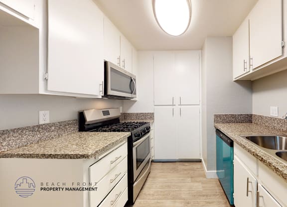 A kitchen with a sink, stove, and refrigerator.
