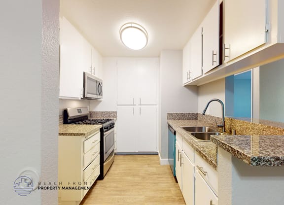 A kitchen with a granite counter top and a sink.