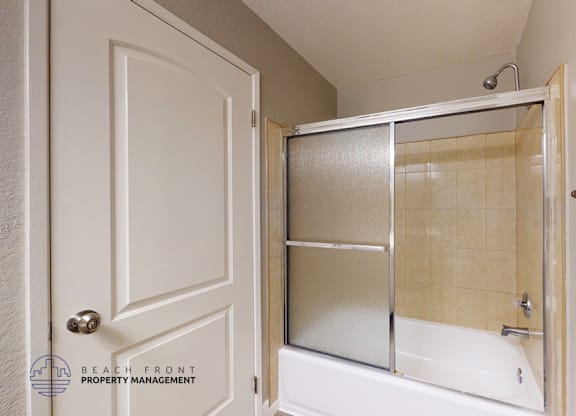 A white door with a glass window is open.