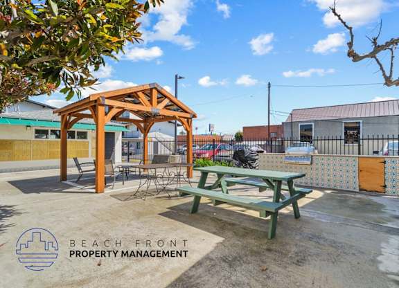 a picnic table in a patio area with a picnic bench