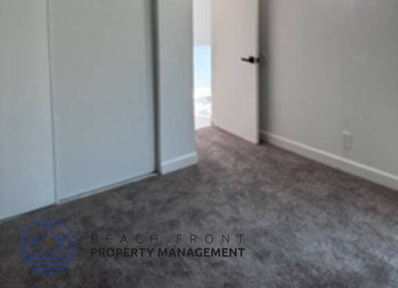 A room with a sliding door and a carpeted floor.