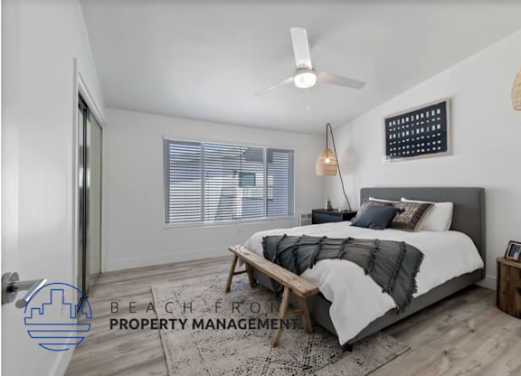a bedroom with a bed and a ceiling fan