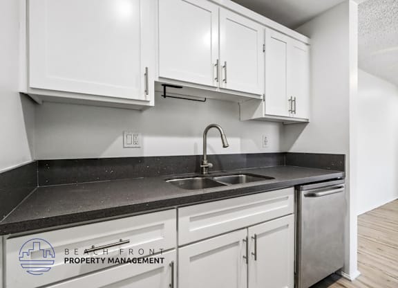 A kitchen with a sink and cabinets.