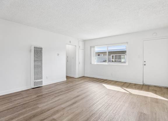 A room with a window and a door.