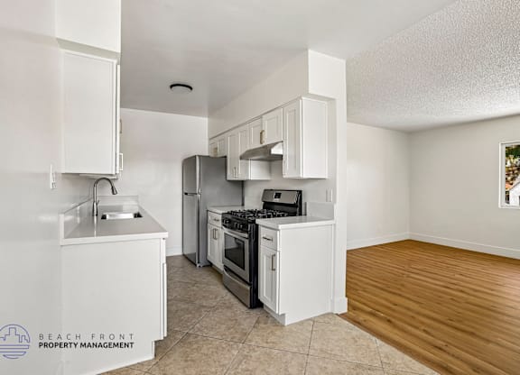 A kitchen with white appliances and cabinets is shown.