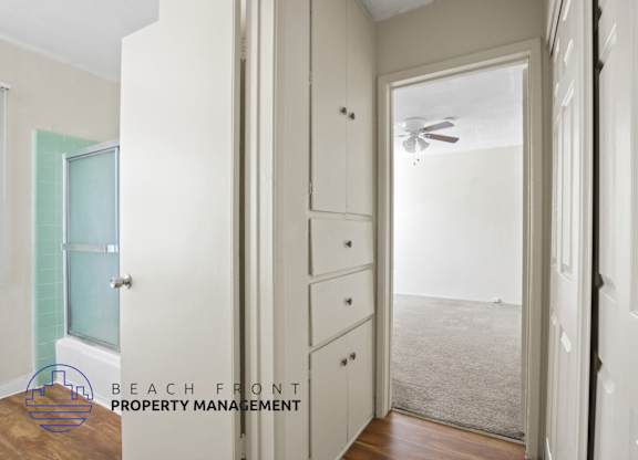 A room with a doorway leading to a hallway.