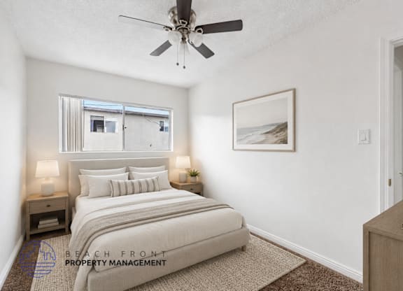 A bedroom with a bed, nightstands, and a ceiling fan.