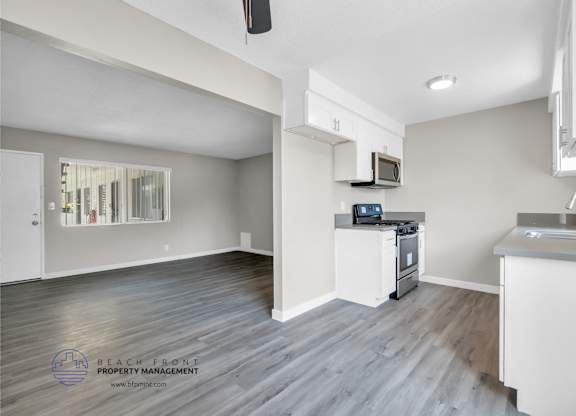 A spacious kitchen and living room with a view of the beach.