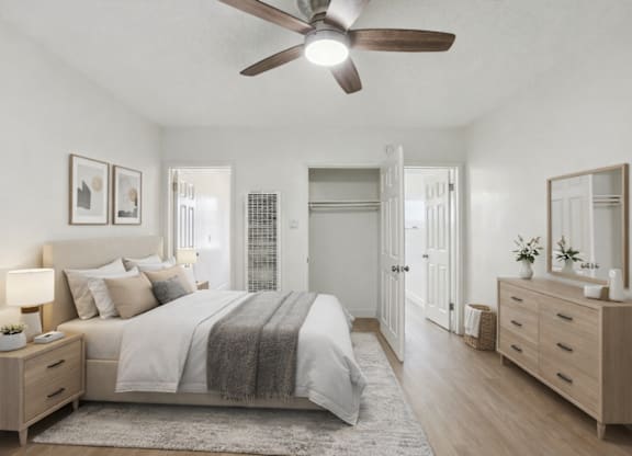 A bedroom with a bed, dresser, and mirror.