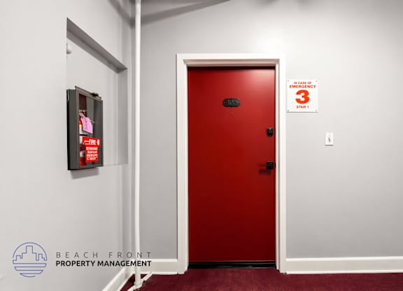 A red door with a sign above it that says