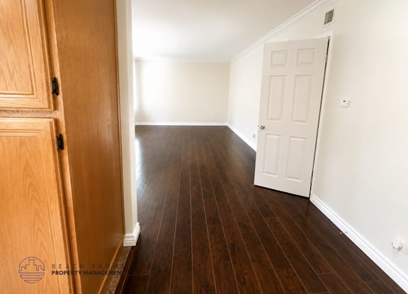 A room with wooden floors and a white door.