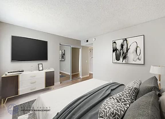 A modern bedroom with a large bed and a television.