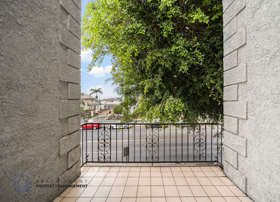 A view from a gate looking out onto a street.