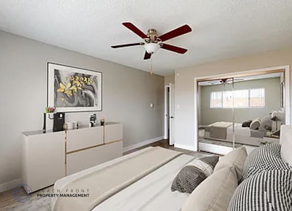 A living room with a ceiling fan and a painting on the wall.