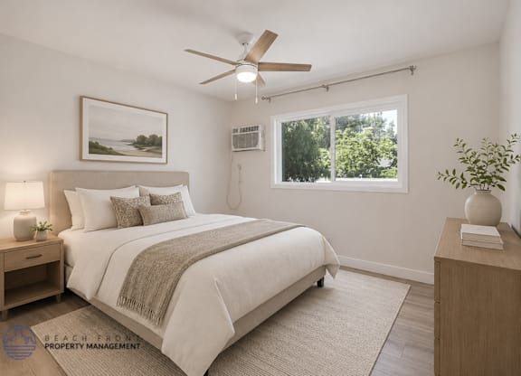 A bedroom with a bed, nightstand, and a painting on the wall.