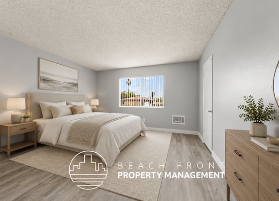 A bedroom with a large bed and a view of the beach through the window.
