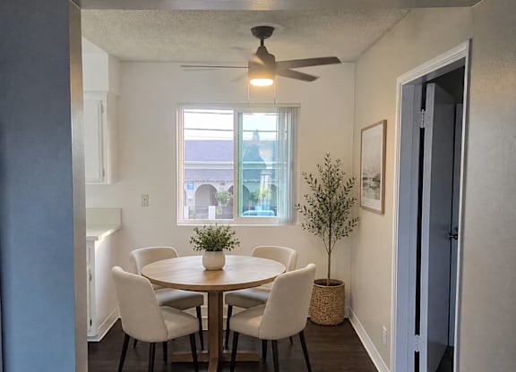 A dining room with a round table and chairs.