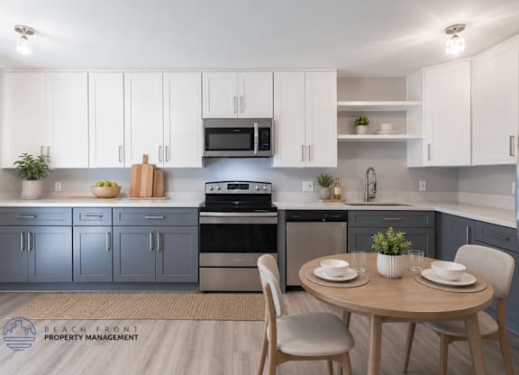 A modern kitchen with a dining table set for two.
